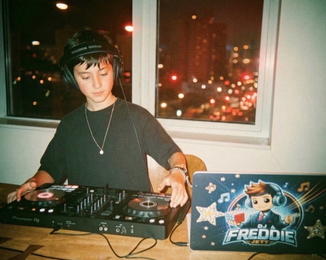 Freddie Jett behind the decks at night in Brooklyn